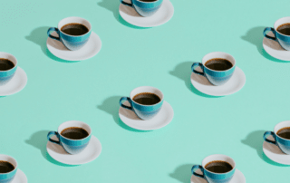 three cups of coffee are sitting on a saucer