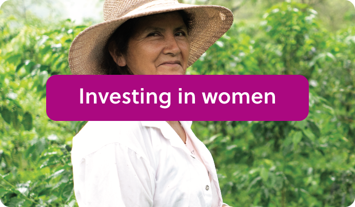 a woman wearing a hat with the words investing in women