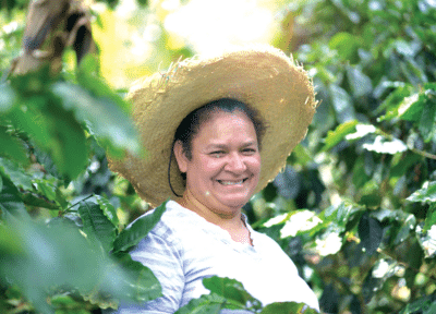 a woman wearing a straw hat in a tree
